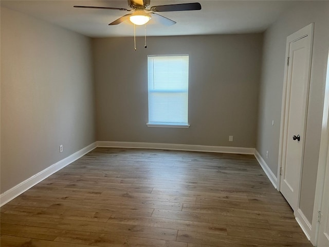 spare room with hardwood / wood-style flooring and ceiling fan