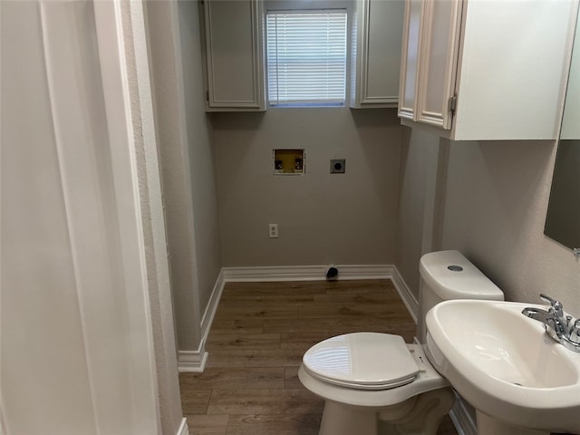 bathroom with toilet, hardwood / wood-style floors, and sink