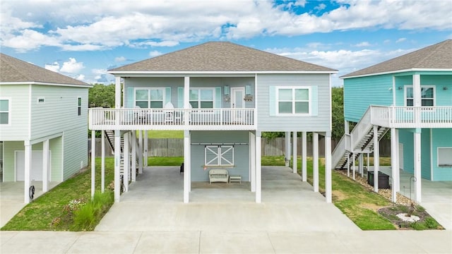 133 Barnacle Dr, Rockport, TX 78382 - exterior space with a shingled roof, stairway, concrete driveway, a yard, and a carport