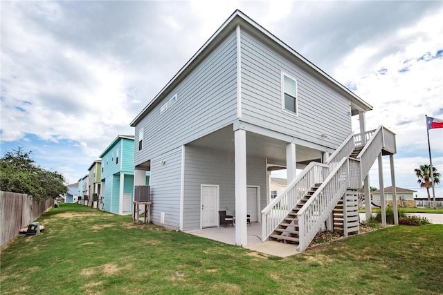 133 Barnacle Dr, Rockport, TX 78382 - back of property featuring fence, stairs, a lawn, a deck, and a patio area