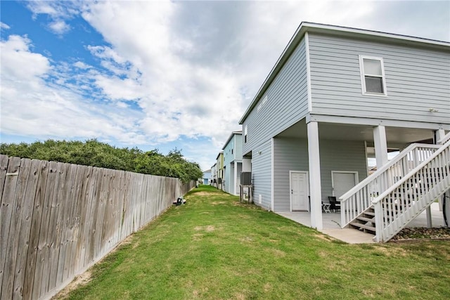133 Barnacle Dr, Rockport, TX 78382 - exterior space with a patio, a lawn, stairs, and fence