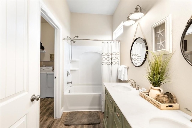 133 Barnacle Dr, Rockport, TX 78382 - full bathroom featuring shower / bath combo with shower curtain, a sink, washer and dryer, wood finished floors, and double vanity