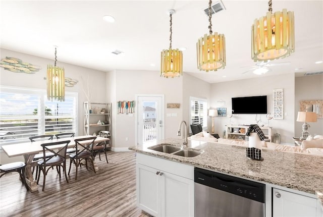 133 Barnacle Dr, Rockport, TX 78382 - kitchen with visible vents, ceiling fan with notable chandelier, stainless steel dishwasher, white cabinetry, and a sink