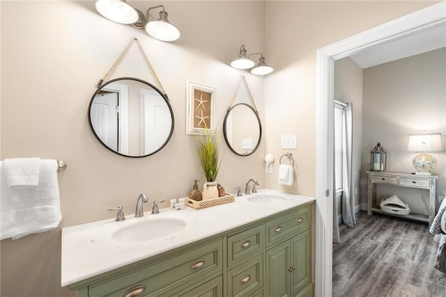 133 Barnacle Dr, Rockport, TX 78382 - ensuite bathroom featuring double vanity, connected bathroom, wood finished floors, and a sink