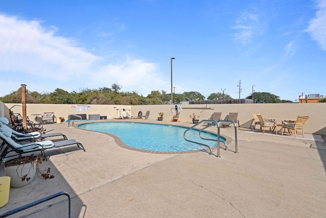 view of swimming pool with a patio area