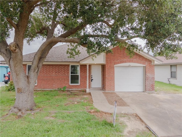 2993 Westlake Dr, Ingleside, TX 78362 - view of front of property with brick siding, roof with shingles, driveway, a garage, and a front lawn