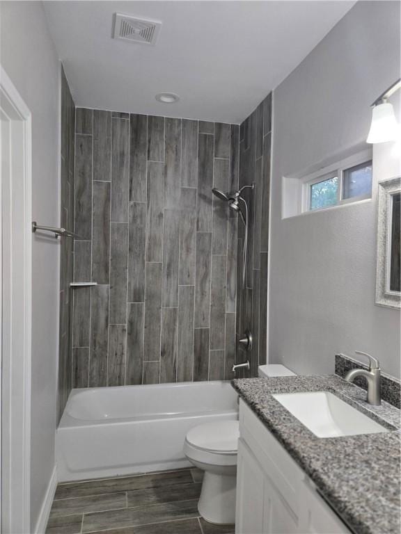 329 N 10th St, Aransas Pass, TX 78336 - full bathroom featuring vanity, bathtub / shower combination, and wood finished floors