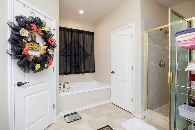 bathroom with independent shower and bath and tile patterned floors