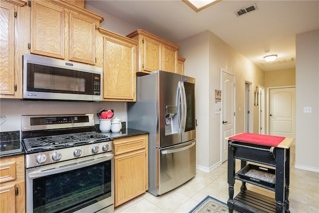 kitchen featuring light brown cabinets, appliances with stainless steel finishes, and light tile patterned floors