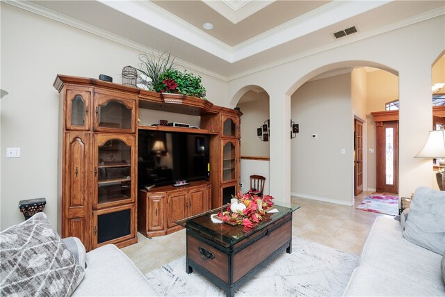 living room with light tile patterned flooring and ornamental molding