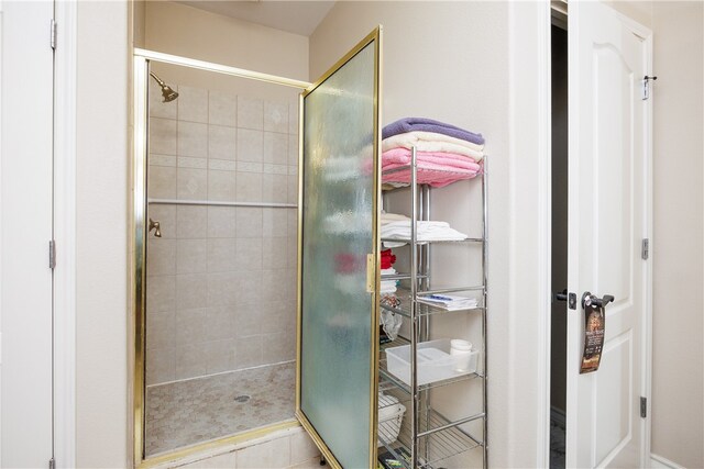 bathroom with walk in shower and tile patterned flooring