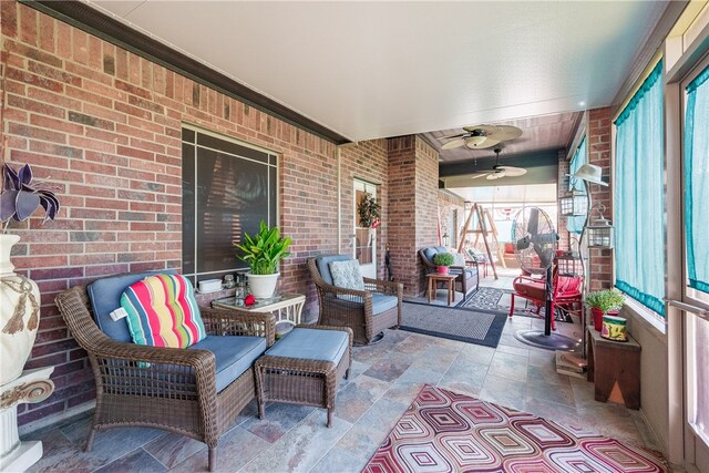 sunroom / solarium featuring ceiling fan and a healthy amount of sunlight