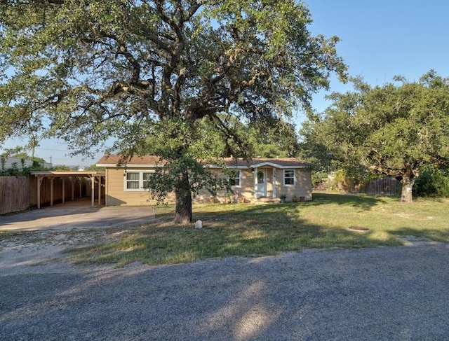 ranch-style house with a front lawn and a carport