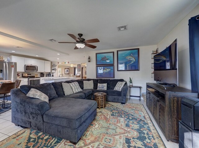 living room featuring ceiling fan and light tile patterned floors