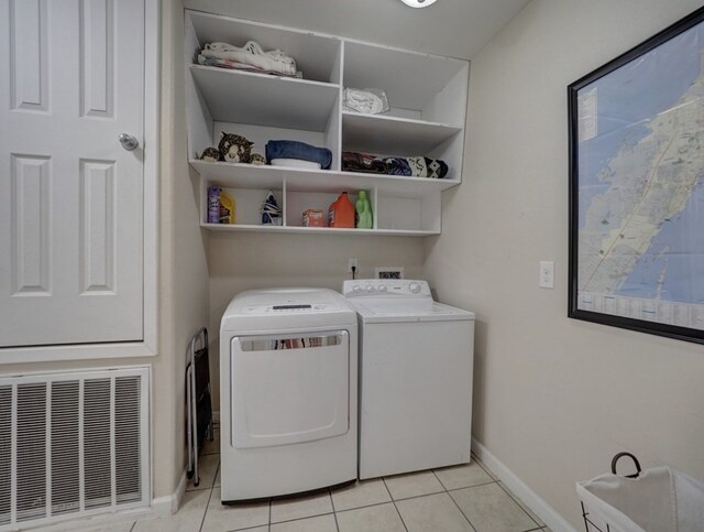 laundry area with light tile patterned flooring and independent washer and dryer