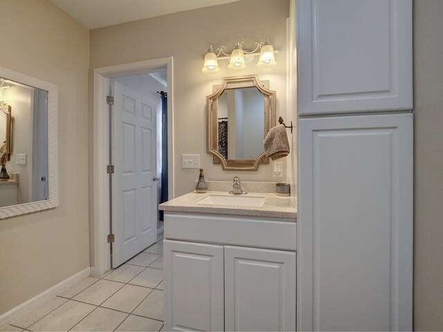 bathroom featuring tile patterned flooring and vanity