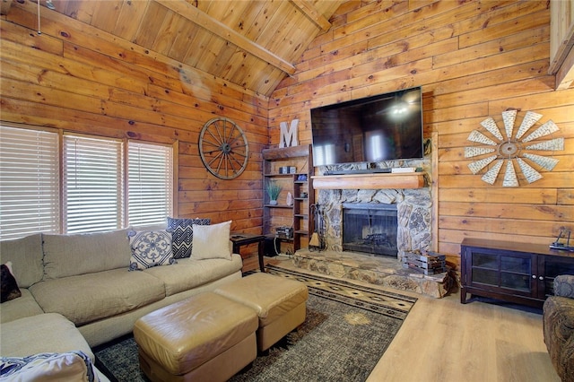 living room featuring a fireplace, high vaulted ceiling, wood walls, wood ceiling, and light hardwood / wood-style floors