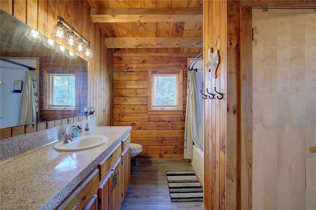 full bathroom with hardwood / wood-style floors, beamed ceiling, plenty of natural light, and wooden walls