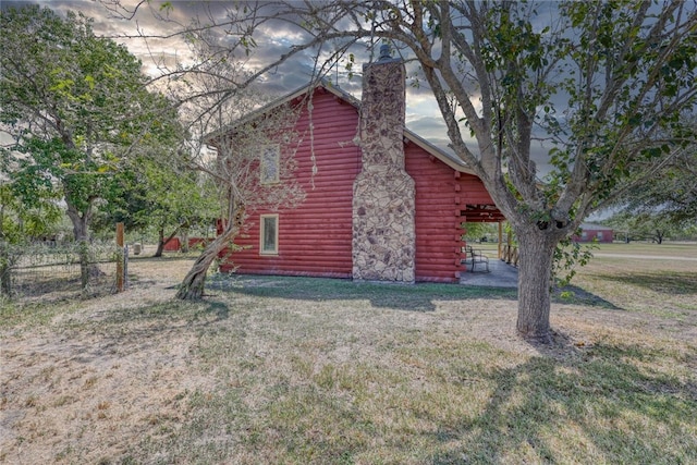 view of side of property with a lawn