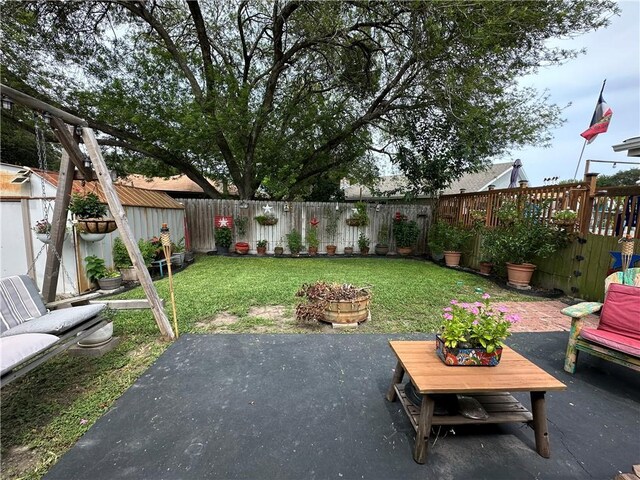 1510 Skyline Dr, Portland, TX 78374 - fenced backyard featuring a patio and a storage unit