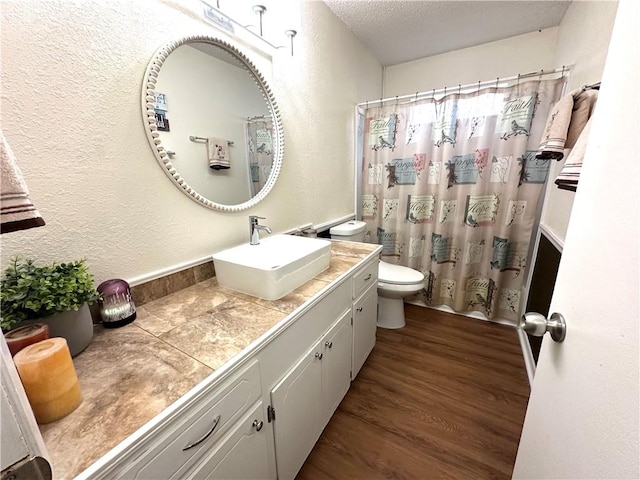1510 Skyline Dr, Portland, TX 78374 - bathroom featuring vanity, wood finished floors, a textured ceiling, a textured wall, and a shower with curtain