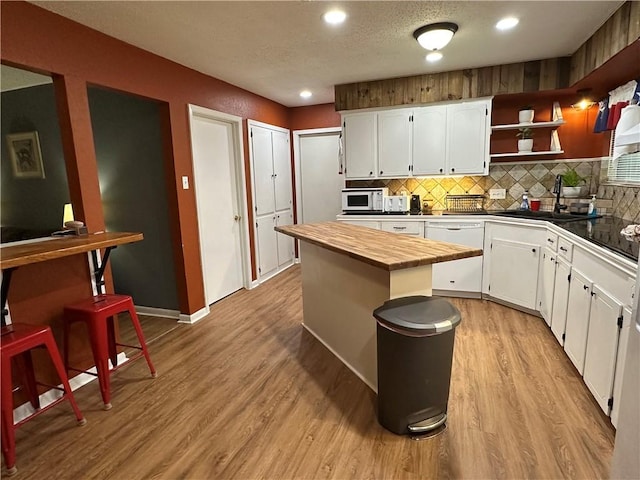 1510 Skyline Dr, Portland, TX 78374 - kitchen featuring white appliances, butcher block counters, white cabinetry, decorative backsplash, and recessed lighting