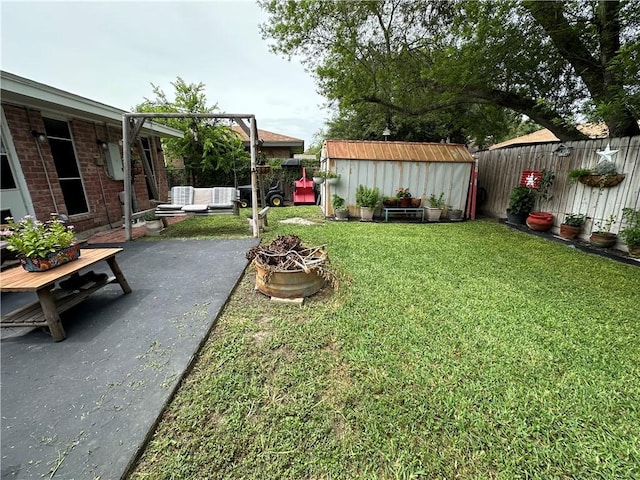 1510 Skyline Dr, Portland, TX 78374 - fenced backyard featuring a storage shed, a fire pit, and a patio area