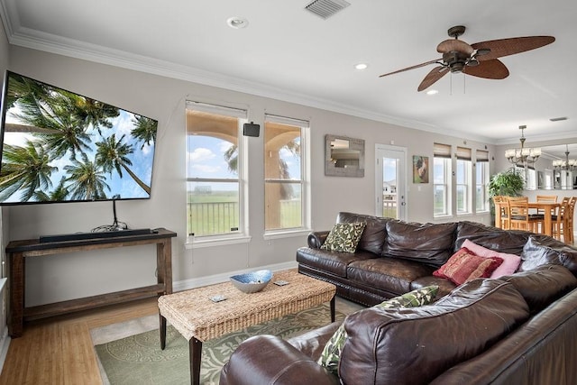 living room with crown molding, hardwood / wood-style flooring, and ceiling fan with notable chandelier