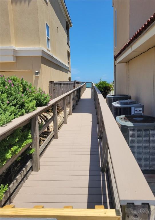 wooden terrace featuring cooling unit