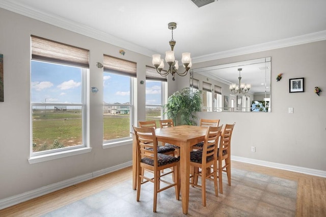 dining area with an inviting chandelier, crown molding, and light hardwood / wood-style floors