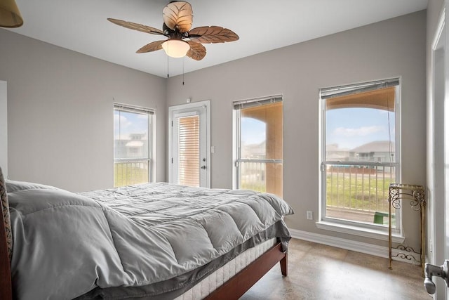 bedroom featuring ceiling fan, multiple windows, and access to outside