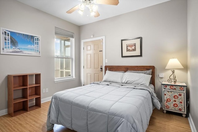 bedroom with ceiling fan and light wood-type flooring