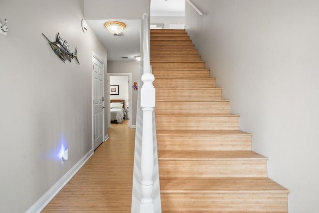 stairway with hardwood / wood-style flooring