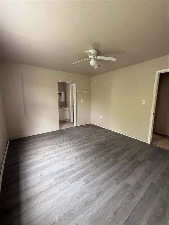 spare room featuring a ceiling fan and wood finished floors