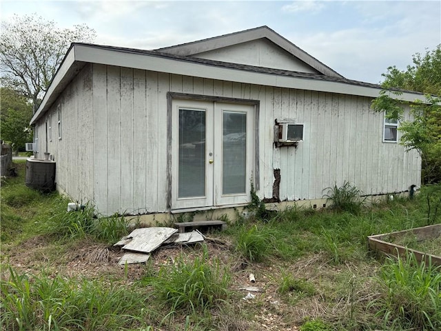 back of house with central air condition unit and french doors