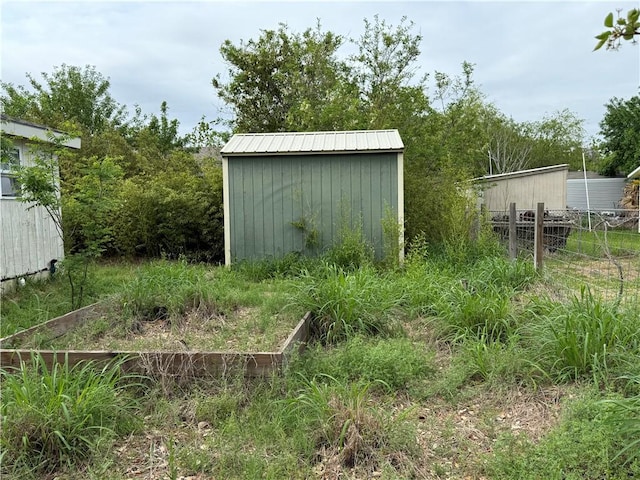 view of shed with fence