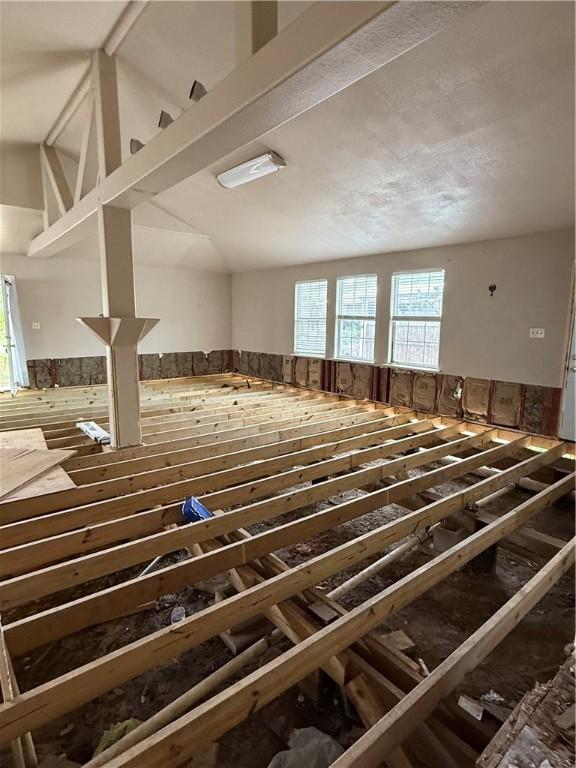 misc room with wooden walls, a wealth of natural light, and a wainscoted wall
