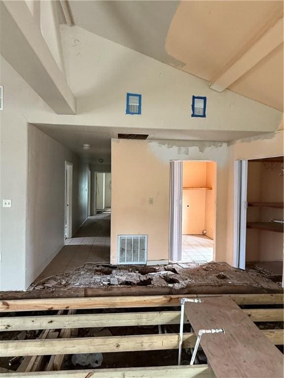 unfurnished room featuring visible vents and high vaulted ceiling