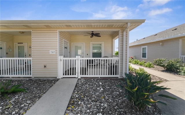 doorway to property featuring ceiling fan and a porch