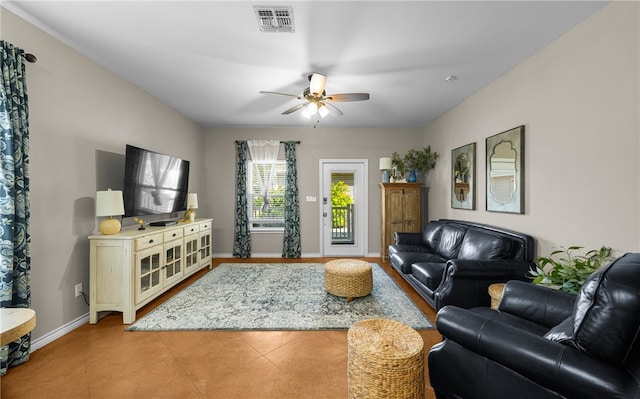 living room featuring ceiling fan and light tile patterned floors