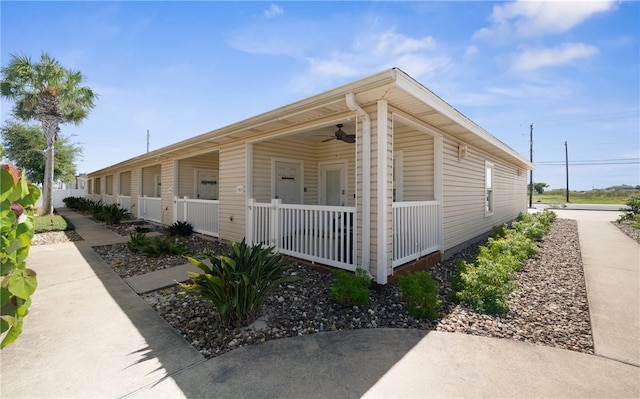 view of side of property with covered porch and ceiling fan