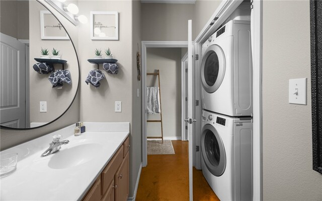 15209 S Padre Island Dr Unit 707, Corpus Christi, TX 78418 - bathroom with stacked washing machine and dryer, concrete floors, and vanity