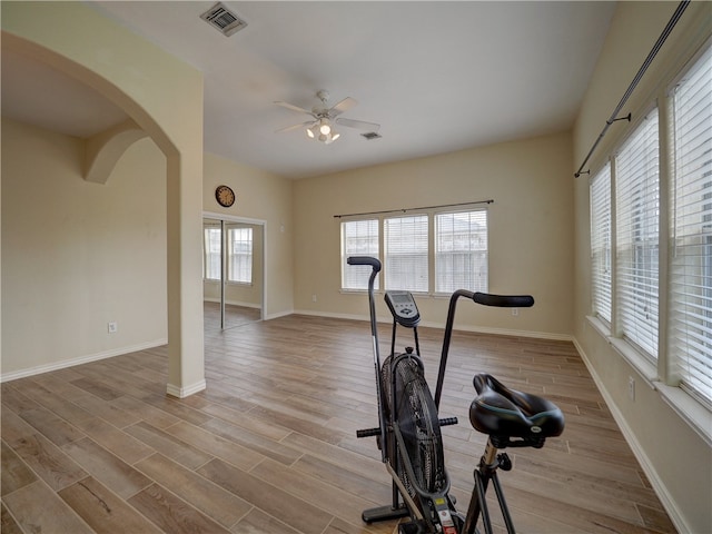 workout area featuring ceiling fan and light hardwood / wood-style floors