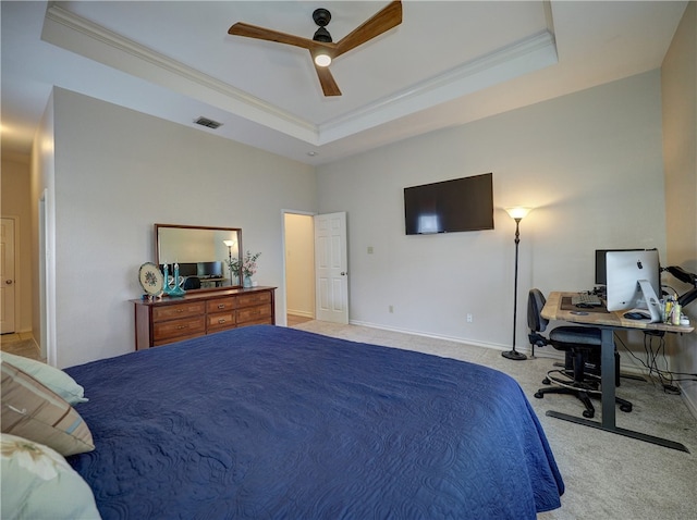 carpeted bedroom featuring ceiling fan, a raised ceiling, and ornamental molding