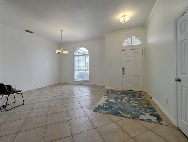 foyer entrance with light tile patterned flooring, an inviting chandelier, and crown molding