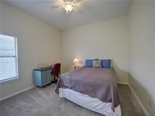 carpeted bedroom with multiple windows and ceiling fan