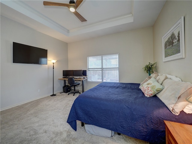 bedroom featuring ornamental molding, light carpet, ceiling fan, and a raised ceiling