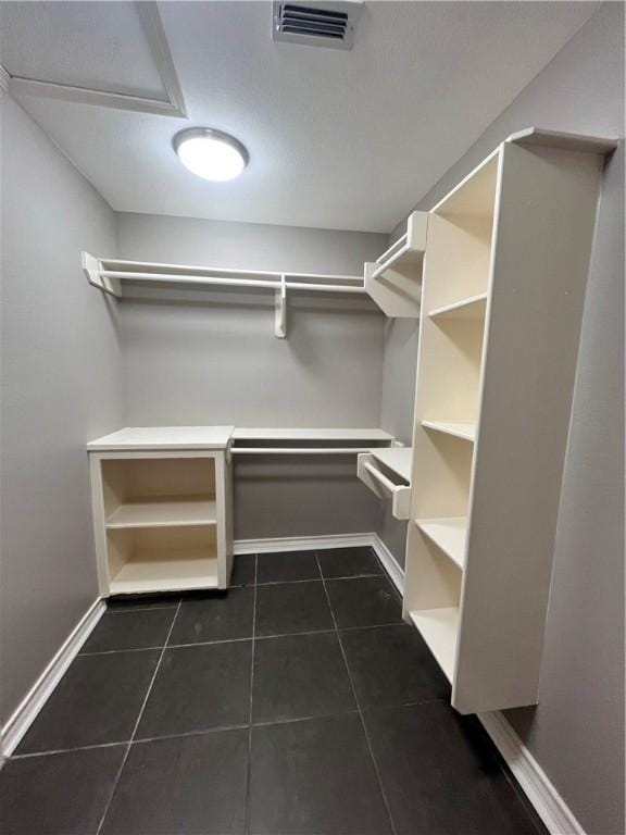 630 Sharon Dr, Corpus Christi, TX 78412 - walk in closet with dark tile patterned flooring