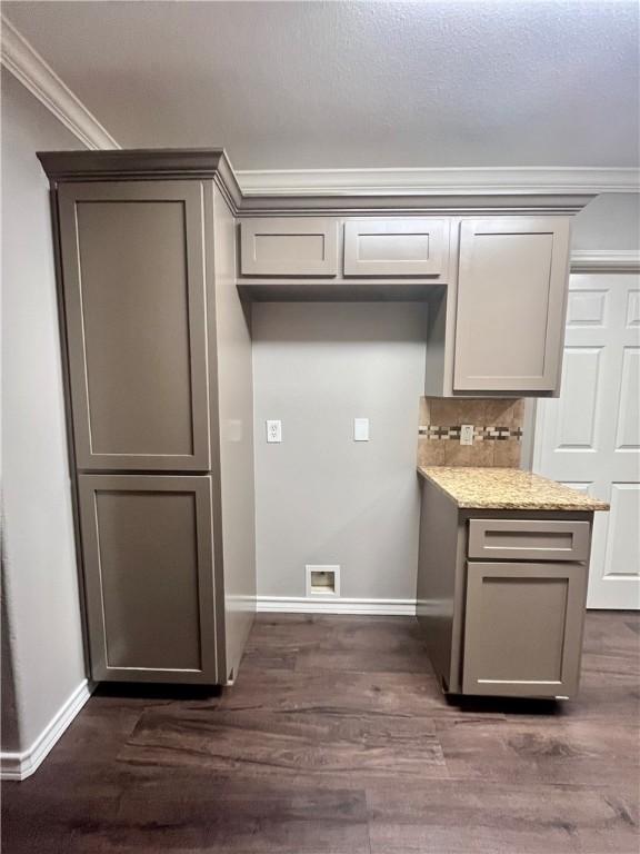 630 Sharon Dr, Corpus Christi, TX 78412 - kitchen featuring crown molding, gray cabinetry, dark wood-style flooring, tasteful backsplash, and light stone countertops