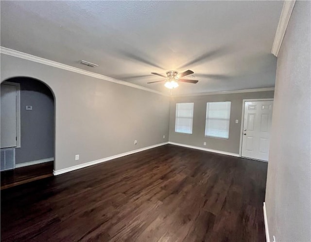 630 Sharon Dr, Corpus Christi, TX 78412 - unfurnished room featuring ceiling fan, dark wood-type flooring, ornamental molding, and arched walkways